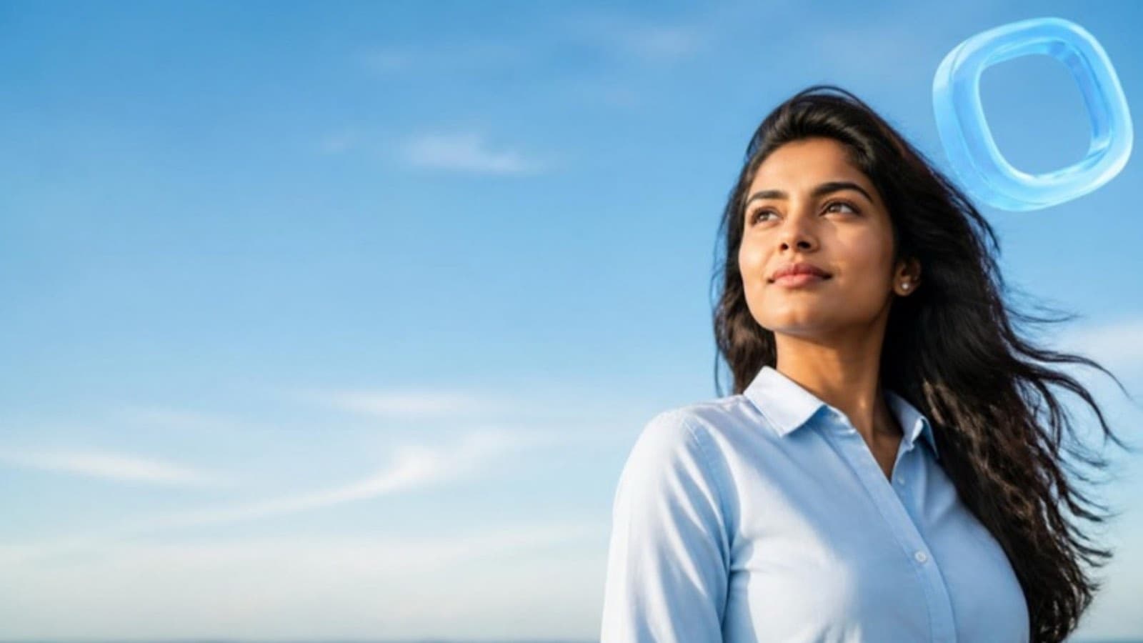 A professional looking up at a clear blue sky, the OceanBlu ring floating beside her