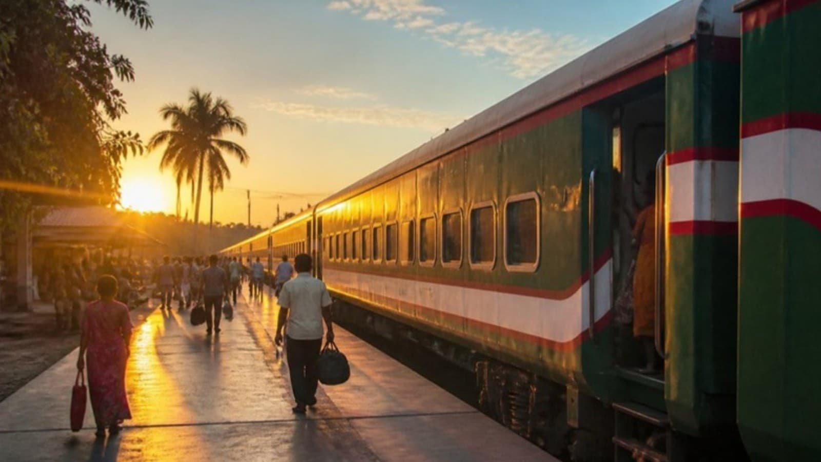 An intercity train at a station platform at sunset